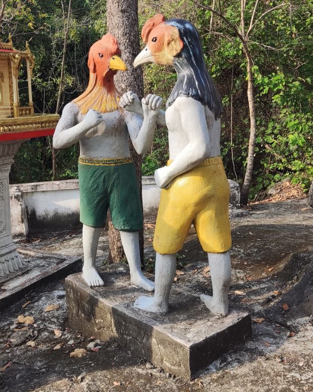 figuras de gallos peleando en el exterior de las killing cave en Battambang, Camboya